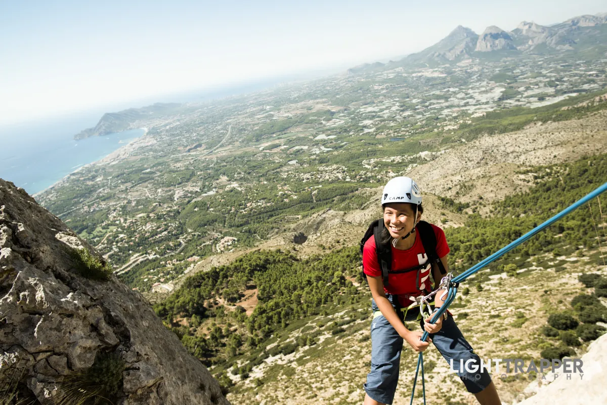 A happy female climber during an abseil