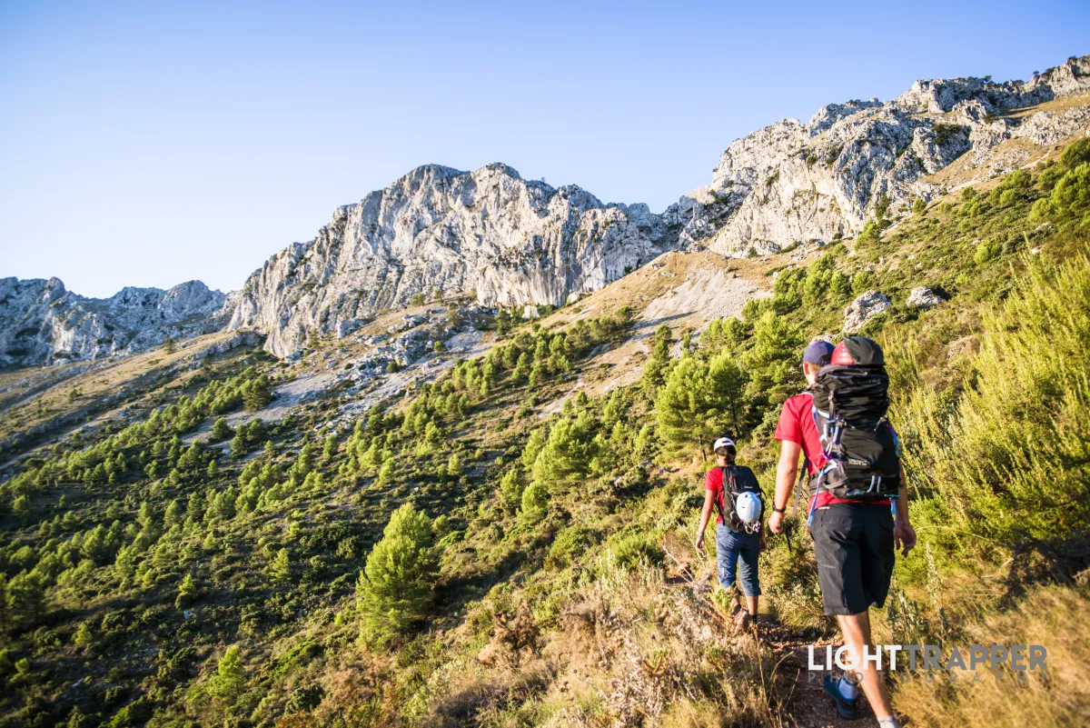 Two climbers traversing the slopes of Sierra Bernia, heading towards Forat