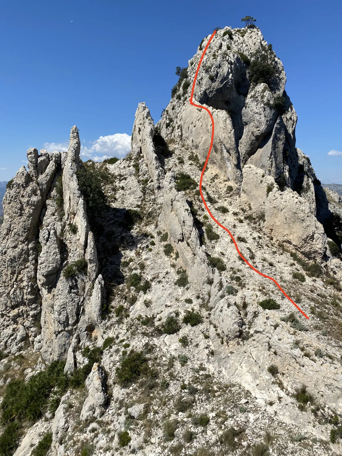 A rocky formation resembling fins, with red line showing the route