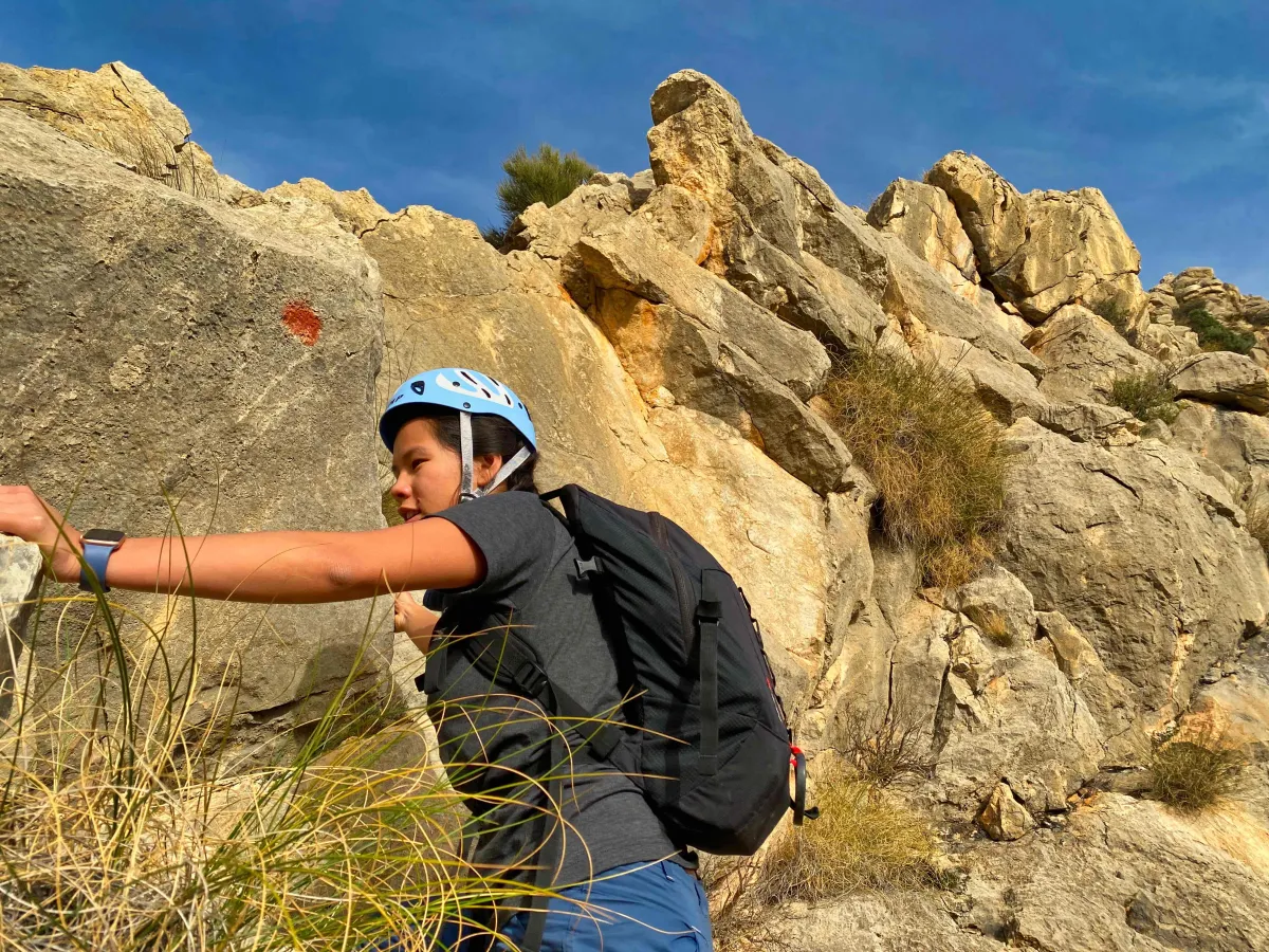 Wendy in a helmet and a red dot painted on the rock