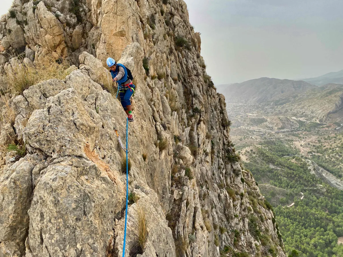 Traversing on the crux of the route; the rope is going through a quickdraw