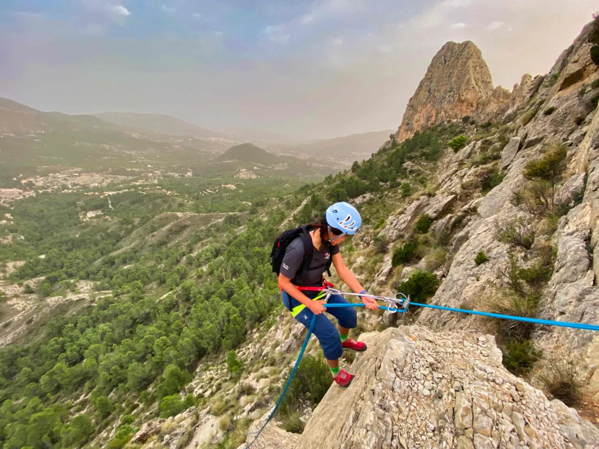 A climber starting a rappel secured by a Prusick