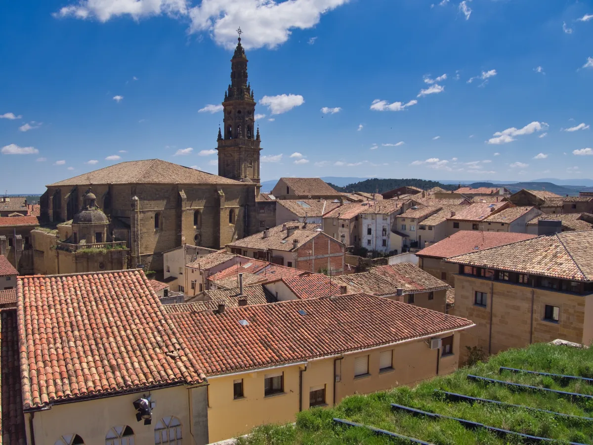 Houses shot from above so their roofs are visible and a church tower